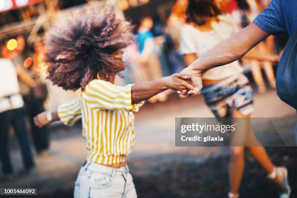 friends dancing at a concert. - hold hands circle stock pictures, royalty-free photos & images