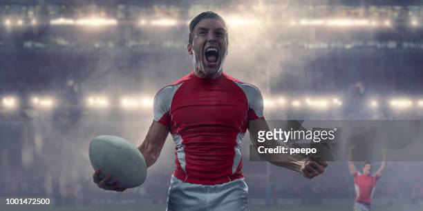 rugby-spieler holding ball und geschrei in siegesfeier - rugby players stock-fotos und bilder