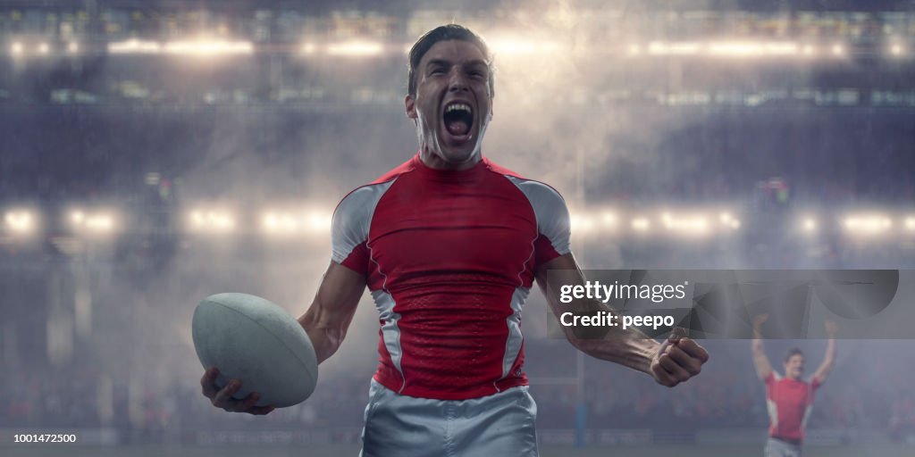 Rugby Player Holding Ball and Shouting in Victory Celebration