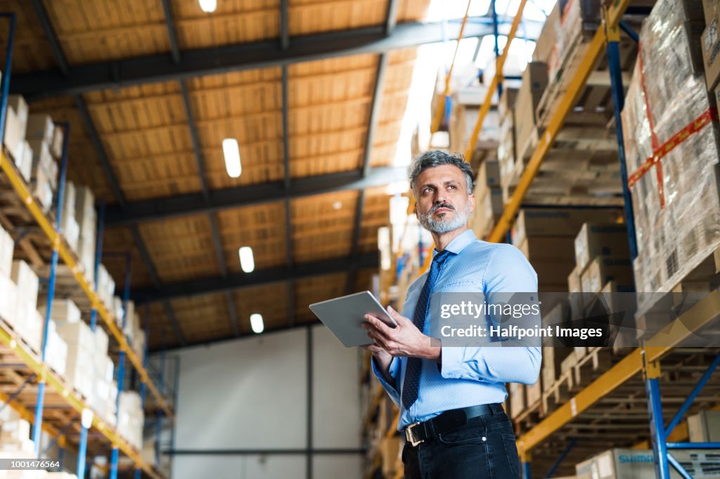 Man Manager Mature Man Manager Or Supervisor Using Tablet In A Warehouse High-Res ...