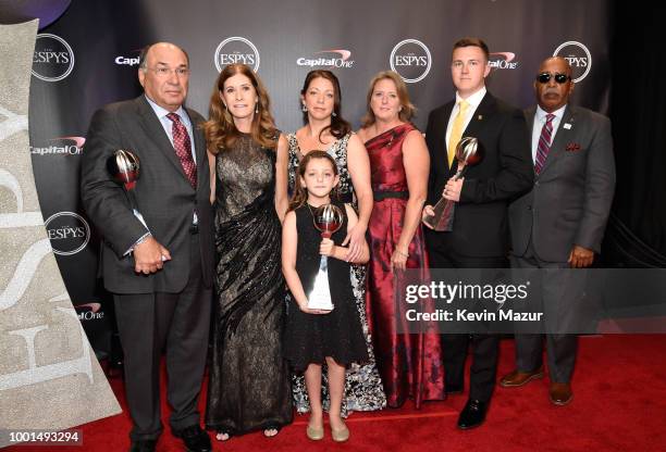 The families and fellow coach of Marjory Stoneman Douglas High School coaches Aaron Feis, Scott Beigel and Chris Hixon, winners of Coach of the Year,...