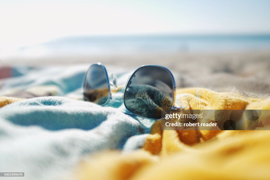 Sunglasses on beach towel