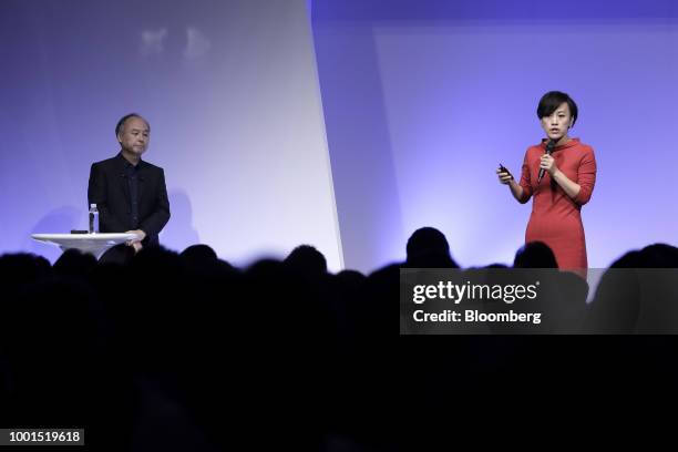 Jean Liu, president of Didi Chuxing, right, speaks as Masayoshi Son, chairman and chief executive officer of SoftBank Group Corp., looks on at the...