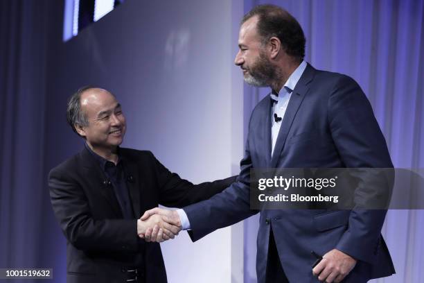 Masayoshi Son, chairman and chief executive officer of SoftBank Group Corp., left, shakes hands with Daniel Ammann, president of General Motors Co.,...