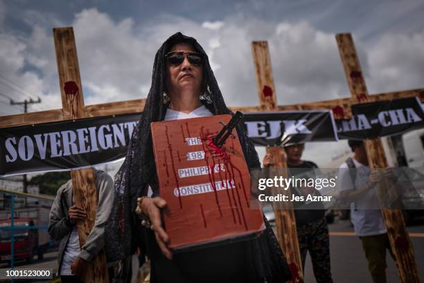 Small group of clergy and civil society members hold a procession with crosses and a coffin to signify the death of democracy under President Duterte...