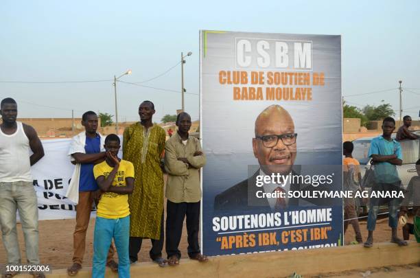 Supporters of Malian incumbent president Ibrahim Boubacar Keita wait at the Gao stadium on July 18, 2018 for a presidential campaign rally.
