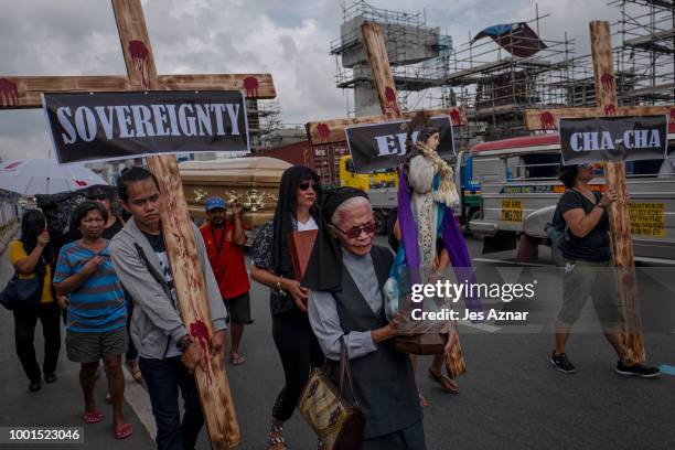 Small group of clergy and civil society members hold a procession with crosses and a coffin to signify the death of democracy under President Duterte...