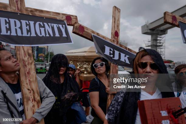 Small group of clergy and civil society members hold a procession with crosses and a coffin to signify the death of democracy under President Duterte...