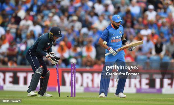 India batsman Virat Kohli reacts as Jos Buttler celebrates after Adil Rashid had bowled Kohli for 71 runs during 3rd ODI Royal London One Day match...