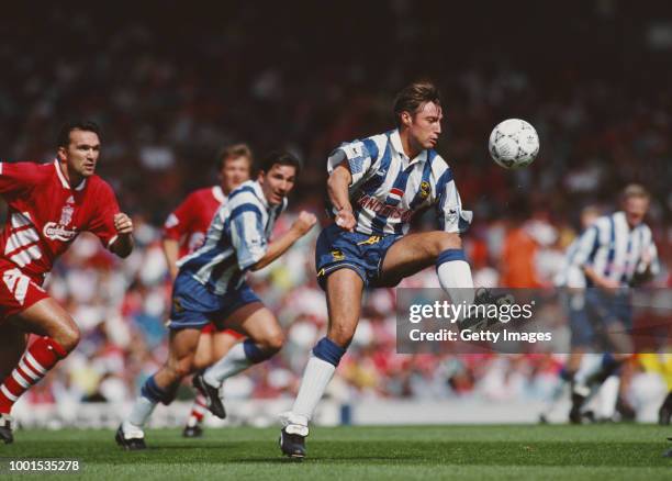 Sheffield Wednesday player Paul Warhurst in action watched by from left, Neil Ruddock, Jan Molby and David Hirst during a Premier League match...