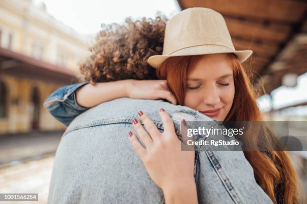 Sad Couple Hugging While Saying Goodbye High-Res Stock Photo - Getty Images