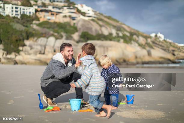 family on winter beach. - llandudno stock-fotos und bilder