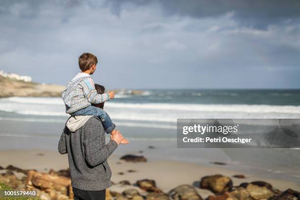 family on winter beach. - llandudno stock pictures, royalty-free photos & images