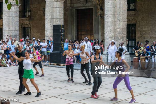 enjoying and dancing on the street at havana, cuba. - cuba street stock pictures, royalty-free photos & images