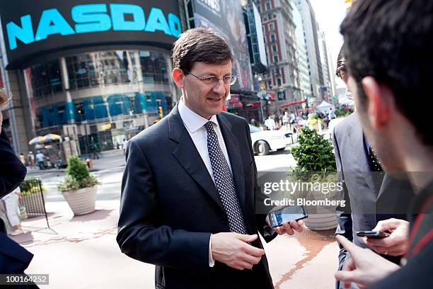 Vittorio Colao, chief executive officer of Vodafone Group Plc, participates in the opening bell ceremony with Robert Greifeld, chief executive...