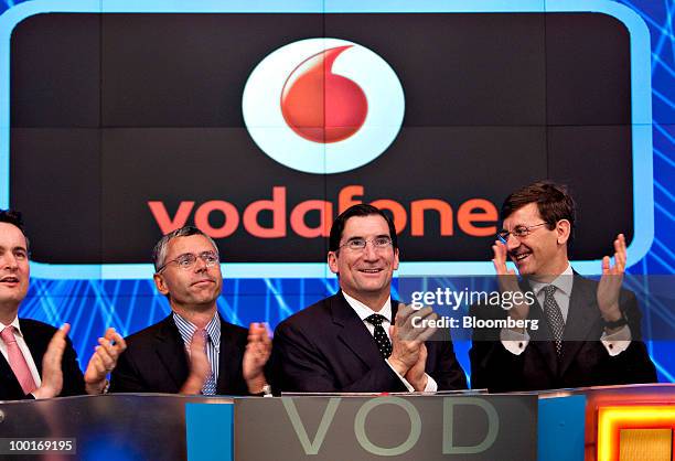 Vittorio Colao, chief executive officer of Vodafone Group Plc, right, participates in the opening bell ceremony with Robert Greifeld, chief executive...