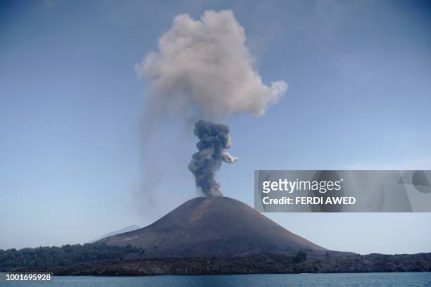 In this photo taken on July 18 A plume of ash rises from Anak Krakatau volcano as seen from Rakata island in South Lampung. - An Indonesian volcano...