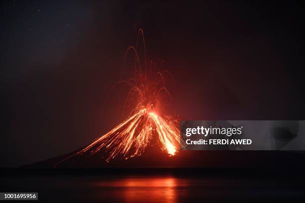 Lava streams down from Anak Krakatau volcano during an eruption as seen from Rakata island in South Lampung on July 19, 2018. - An Indonesian volcano...