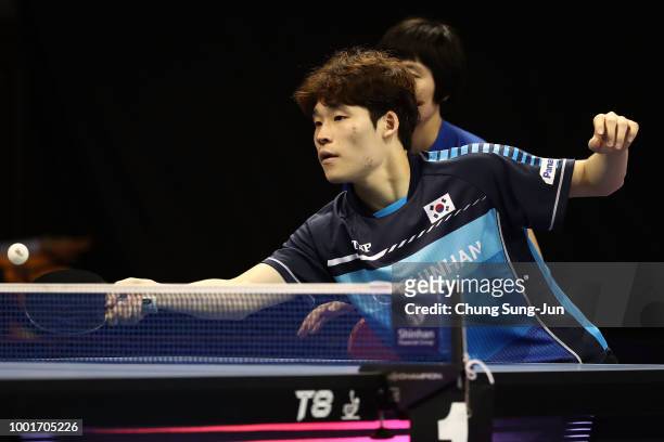 Jang Woo-Jin of South Korea and Cha Hyo-Sim of North Korea compete against Ho Kwan Kit and Lee Ho-Ching of Hong Kong in the Mixed Double -...