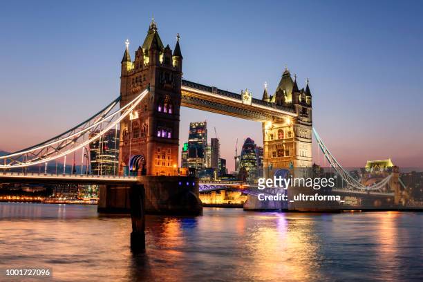tower bridge and city of london at dusk - bascule bridge stock pictures, royalty-free photos & images