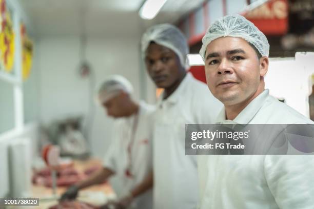 group of people working at the butchery - portrait - meat packing stock pictures, royalty-free photos & images