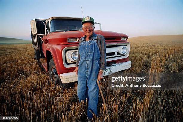 elderly farmer with cane and truck in field in washington - old truck fotografías e imágenes de stock