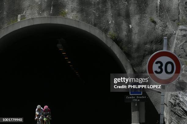 France's Warren Barguil and France's Pierre Rolland exit a tunnel as they ride in a counter attack group during the twelfth stage of the 105th...