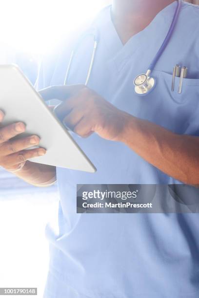 doctor updating medical records - electronic medical record stock pictures, royalty-free photos & images
