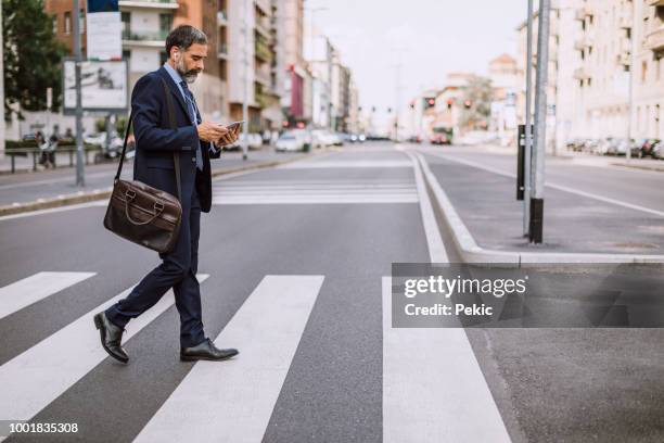 businessman on zebra crossing - crossroad stock pictures, royalty-free photos & images