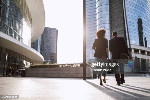 couple walking home from work - milan financial district stock pictures, royalty-free photos & images