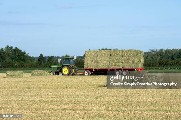 tractor and wagon loaded with hay - small square stock pictures, royalty-free photos & images