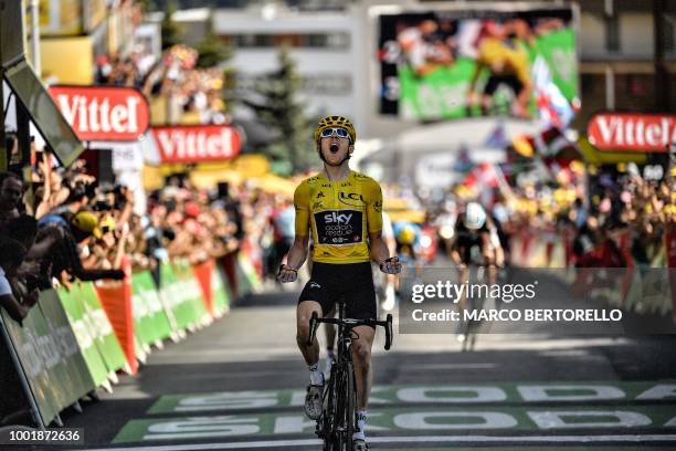 Great Britain's Geraint Thomas, wearing the overall leader's yellow jersey, celebrates as he crosses the finish line to win the twelfth stage of the...