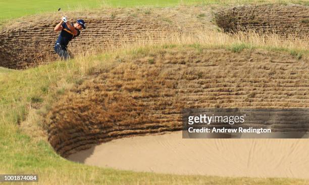 Henrik Stenson of Sweden hits his second shot from a bunker on the 16th hole during the first round of the 147th Open Championship at Carnoustie Golf...