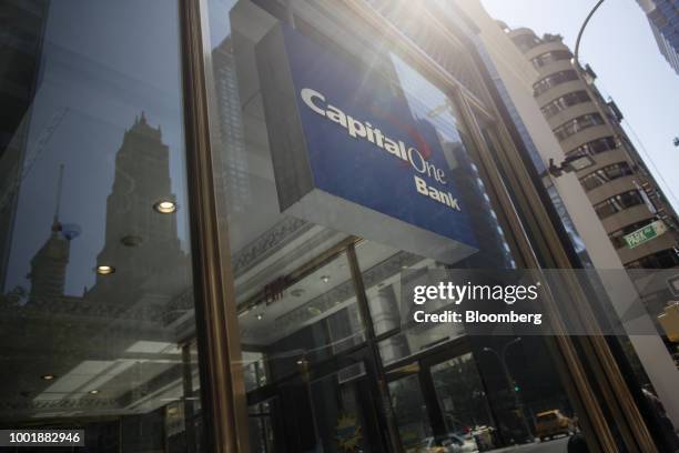 Signage is displayed inside the window of a Capital One Financial Corp. Bank branch in New York, U.S., on Wednesday, July 19, 2018. Capital One...