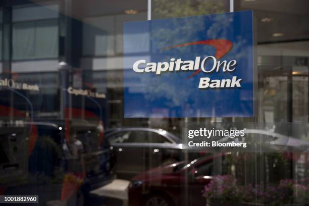 Signage is displayed inside the window of a Capital One Financial Corp. Bank branch in New York, U.S., on Wednesday, July 19, 2018. Capital One...