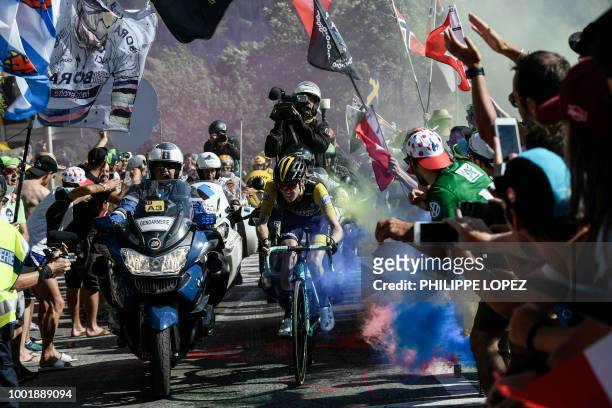 Netherlands' Steven Kruijswijk rides through flare bomb smoke in the ascent to l'Alpe d'Huez during the twelfth stage of the 105th edition of the...