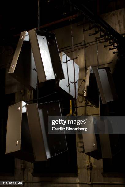 Steel tool chest shelves move through a conveyor before being power washed at a Stanley Black & Decker Inc. Craftsman Tools manufacturing facility in...