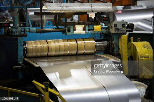 Metal moves through a flattening machine at a Stanley Black & Decker Inc. Craftsman Tools manufacturing facility in Sedalia, Missouri, U.S., on...