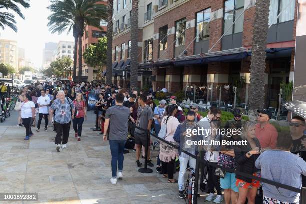 Fans wait in line for The DC UNIVERSE Experience at Comic-Con International which brings to life the originals, classics and comics soon to be...
