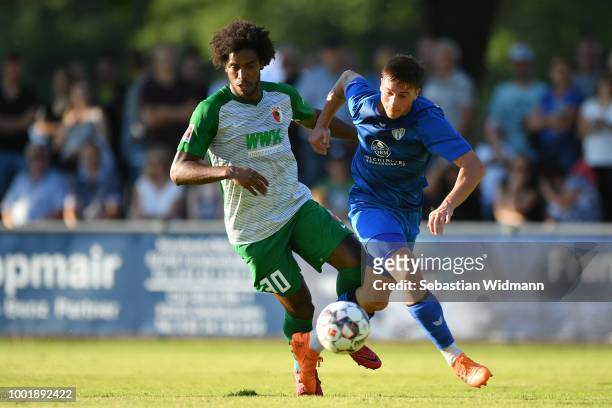 Francisco da Silva Caiuby of Augsburg and Christos Nikiforidis of Olching compete for the ball during the pre-season friendly match between SC...