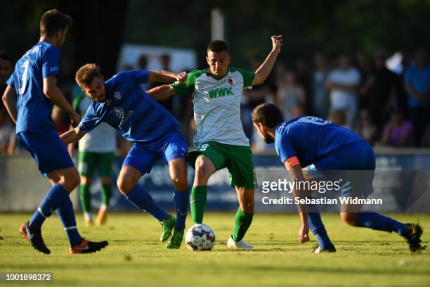 Romario Roesch of Augsburg and Paul Niehaus of Olching compete for the ball during the pre-season friendly match between SC Olching and FC Augsburg...