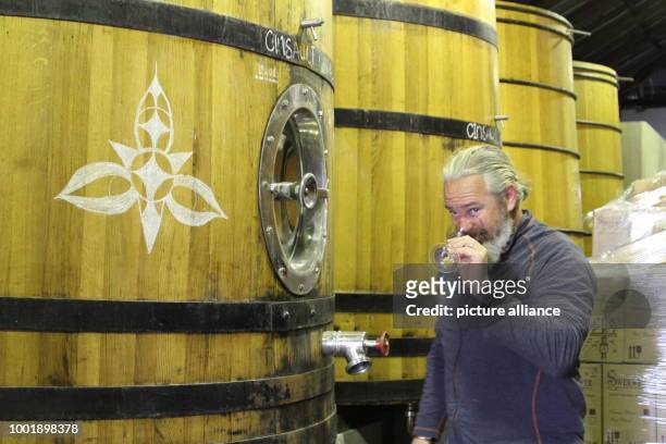 Winemaker Adi Badenhorst fetches a glass of Grenache from this year's harvest at his vinyard between Wellington and Paarl, South Africa, 20 July...