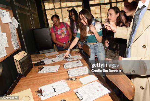 Fans help to solve the whereabouts of Dick Grayson in the Titans loft during the DC UNIVERSE Experience at Comic-Con International on July 19, 2018...