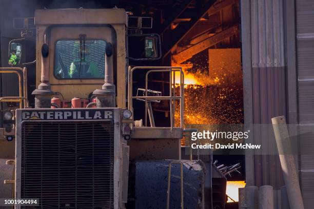 Tractor carries some of approximately 3,500 confiscated guns into Gerdau Steel Mill to be melted down understand supervision of the Los Angeles...