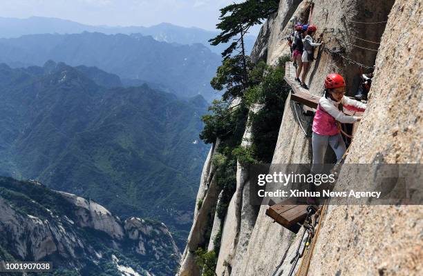 July 19, 2018 : Tourists navigate Chang Kong Plank Road at Huashan Mountain in Huayin City, northwest China's Shaanxi Province, July 18, 2018. Built...