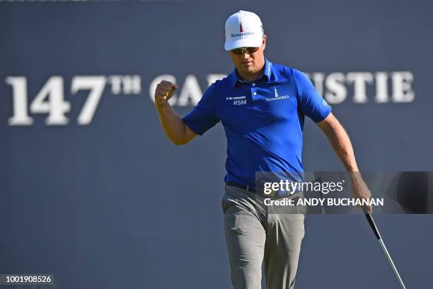 Golfer Zach Johnson celebrates after making a birdie putt on the 18th green during his first round on day one of The 147th Open golf Championship at...