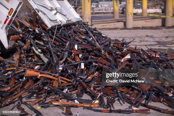 Truck dumps approximately 3,500 confiscated guns to be destroyed into a pile at Gerdau Steel Mill on July 19, 2018 in Rancho Cucamonga, California....