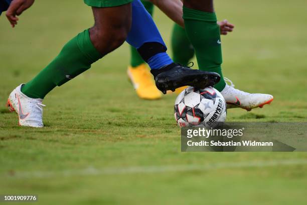 Detail shot of the legs of a player of Olching and Augsburg while competing for the ball during the pre-season friendly match between SC Olching and...