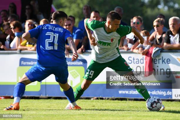 Romario Roesch of Augsburg and Christos Nikiforidis of Olching compete for the ball during the pre-season friendly match between SC Olching and FC...