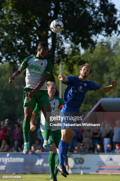 Kevin Danso of Augsburg and Mikotaj Simon of Olching jump for a header during the pre-season friendly match between SC Olching and FC Augsburg on...